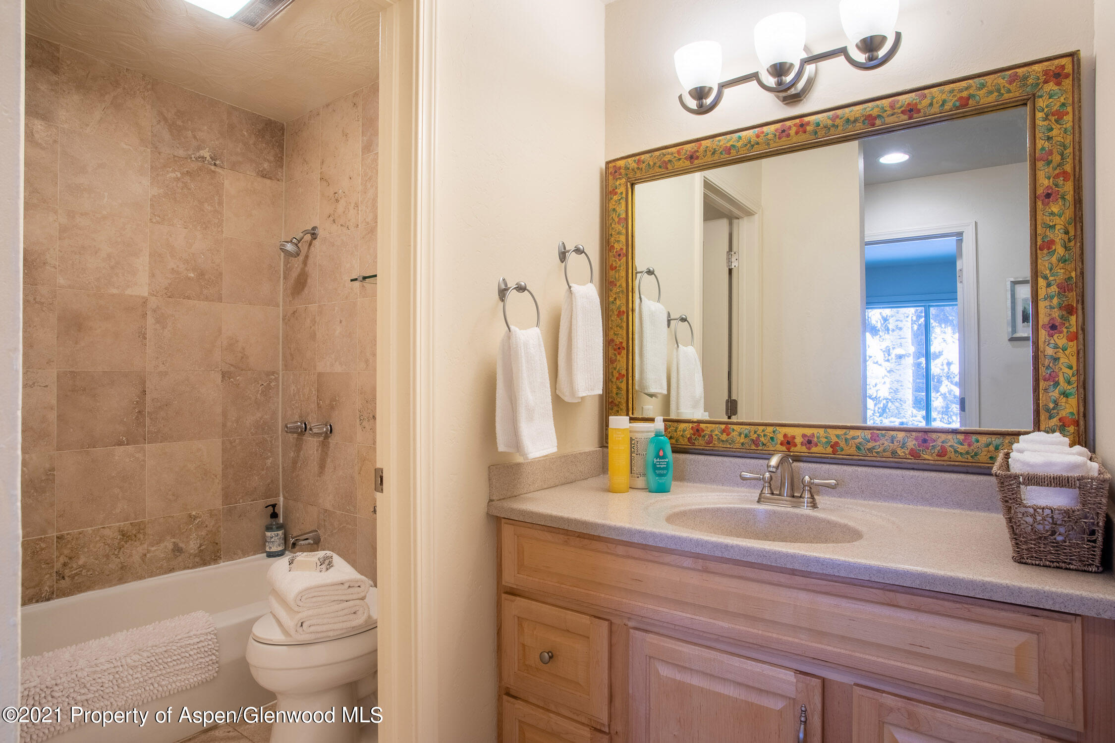 35 Lower Woodbridge Road, Unit 155 Snowmass Village, CO 81615 - Photo 13 of 14 a bathroom with a double vanity sink and mirror with shower