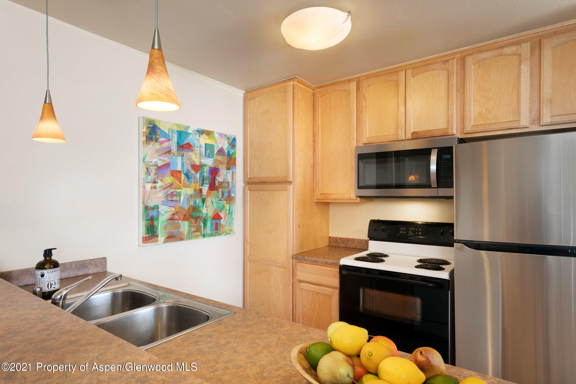 35 Lower Woodbridge Road, Unit 155 Snowmass Village, CO 81615 - Photo 4 of 14 a kitchen with stainless steel appliances a sink a stove a microwave a refrigerator and cabinets
