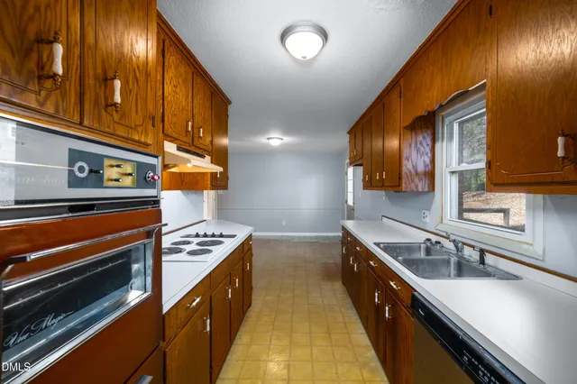 a kitchen with stainless steel appliances a sink stove and cabinets