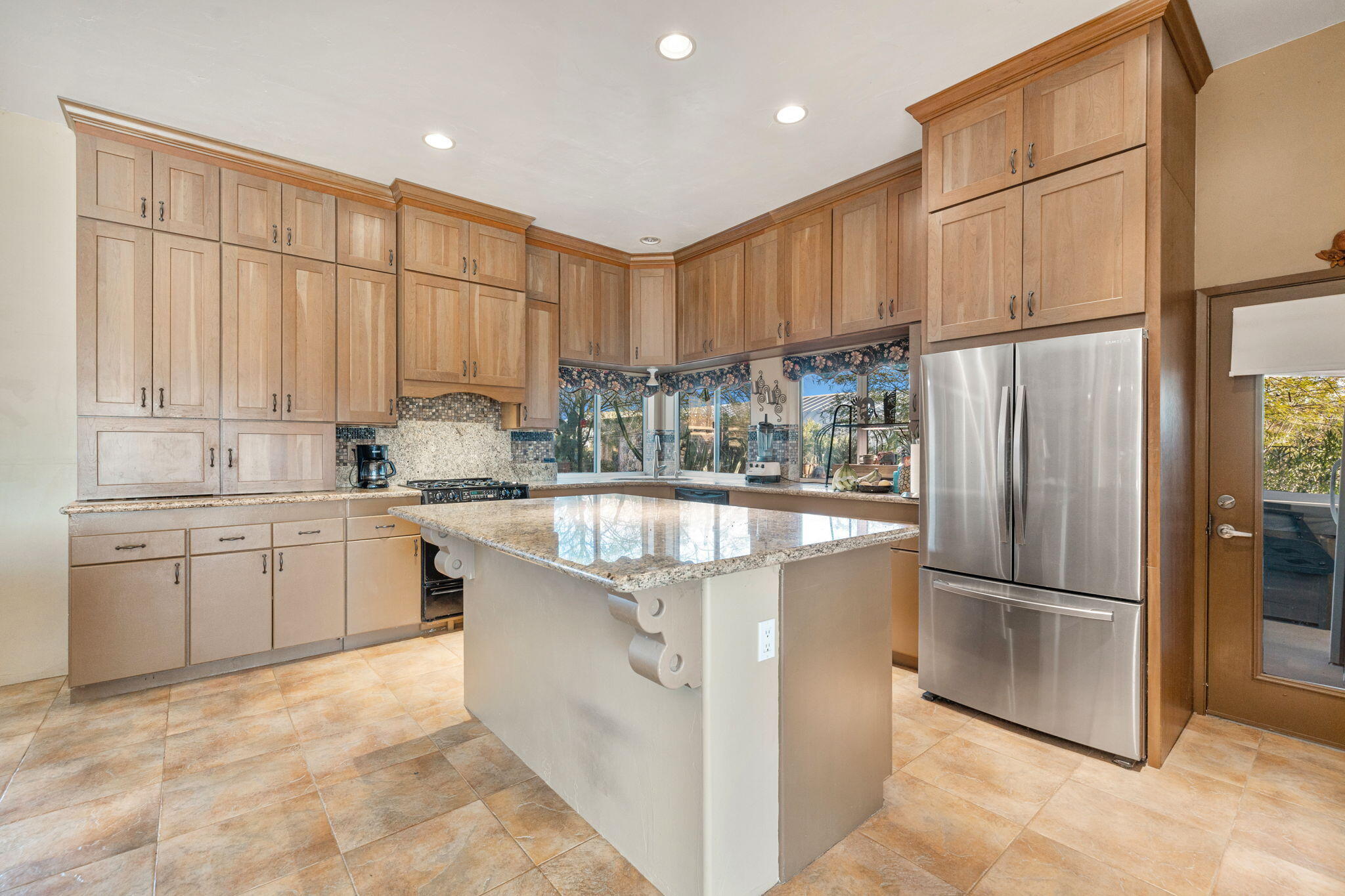 22950 Henry Road Desert Hot Springs, CA 92241 - Photo 13 of 68 a kitchen with stainless steel appliances granite countertop a refrigerator a sink dishwasher a stove with wooden cabinets and a granite counter top