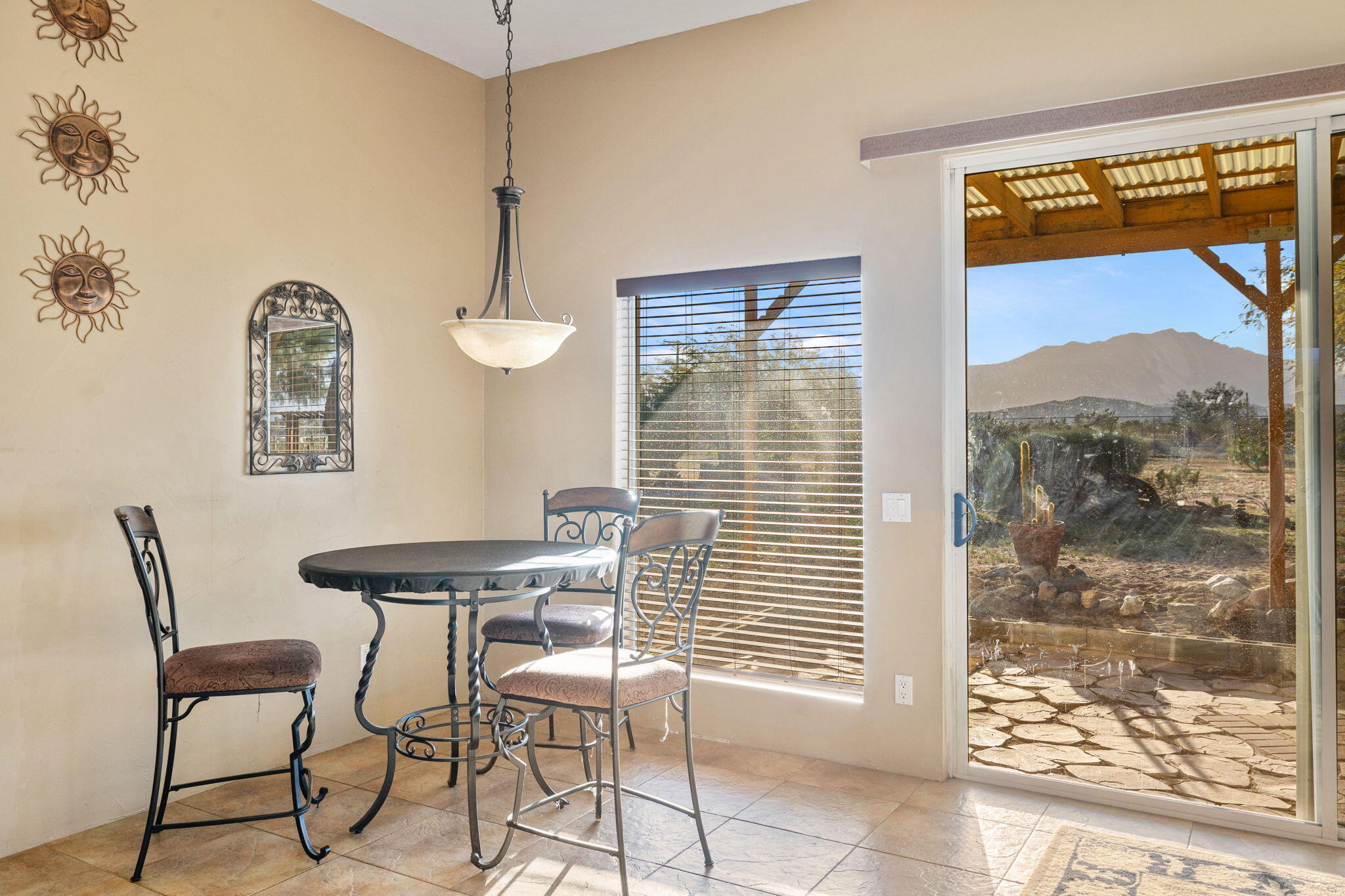 22950 Henry Road Desert Hot Springs, CA 92241 - Photo 14 of 68 a dining room with furniture and a window