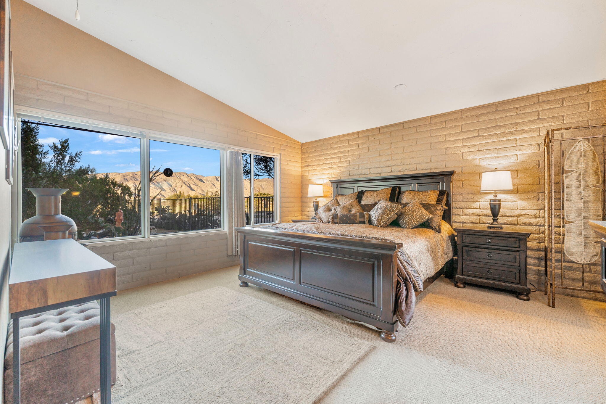 22950 Henry Road Desert Hot Springs, CA 92241 - Photo 16 of 68 a bedroom with a large bed and a dresser
