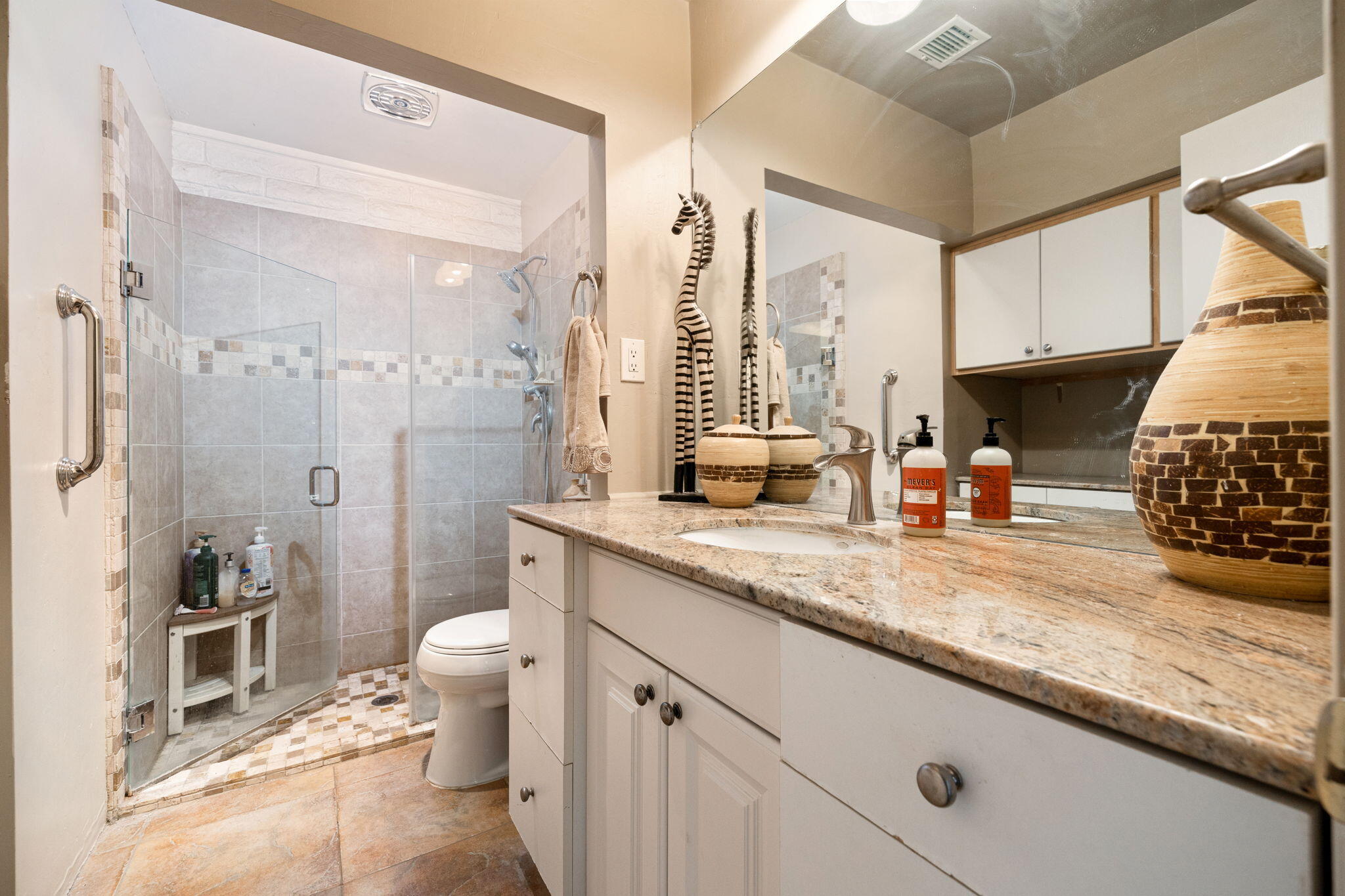 22950 Henry Road Desert Hot Springs, CA 92241 - Photo 19 of 68 a bathroom with a granite countertop sink a toilet a mirror and shower