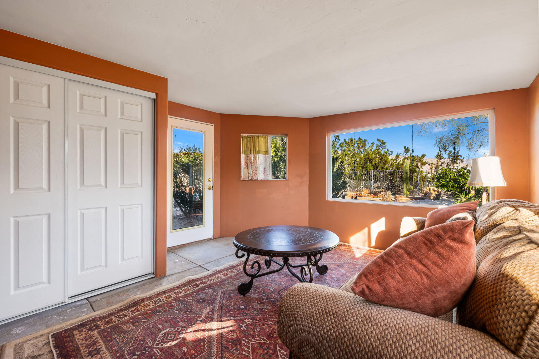 22950 Henry Road Desert Hot Springs, CA 92241 - Photo 23 of 68 a living room with furniture a rug and a window