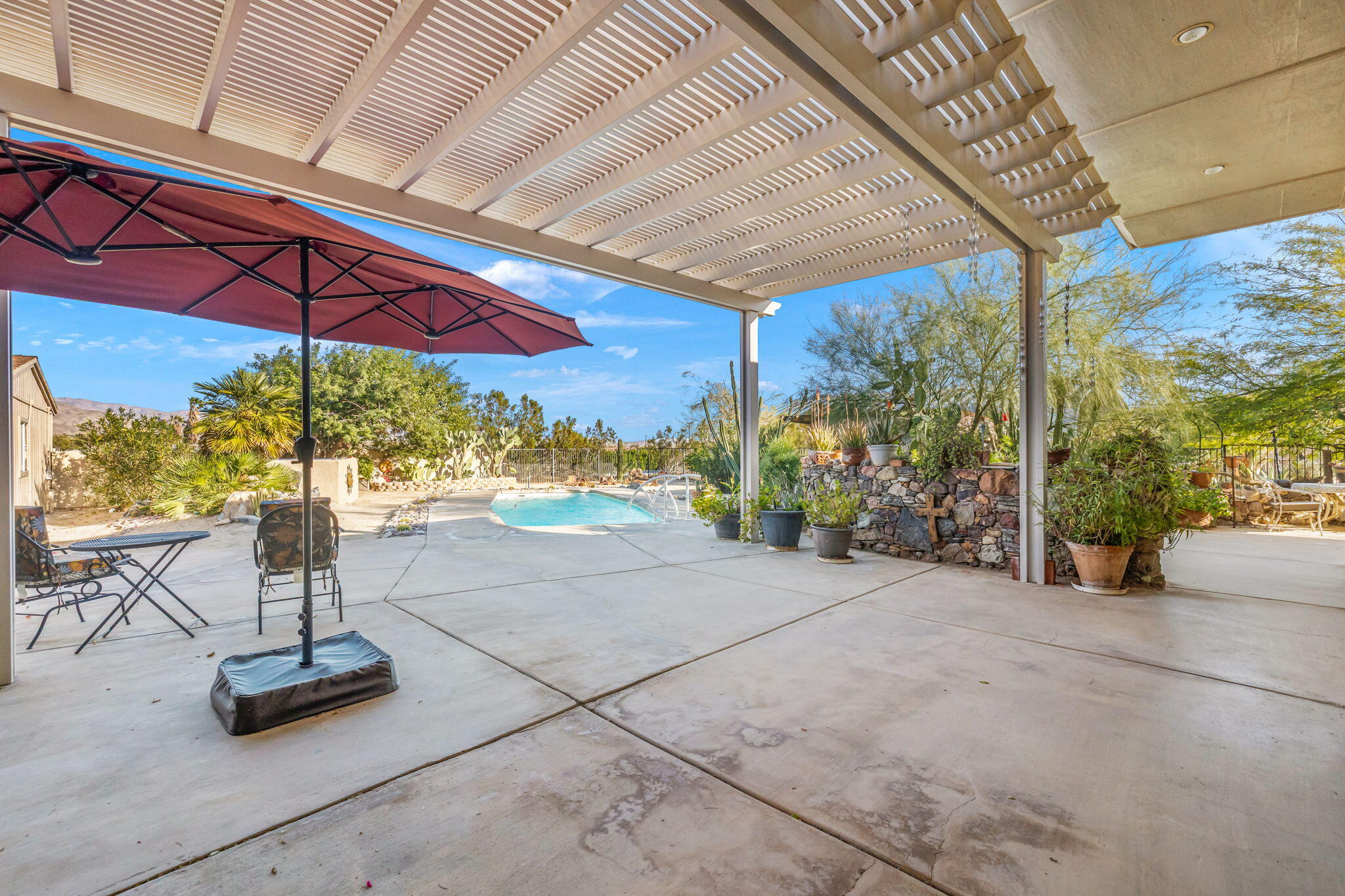 22950 Henry Road Desert Hot Springs, CA 92241 - Photo 30 of 68 a view of a swimming pool with a patio
