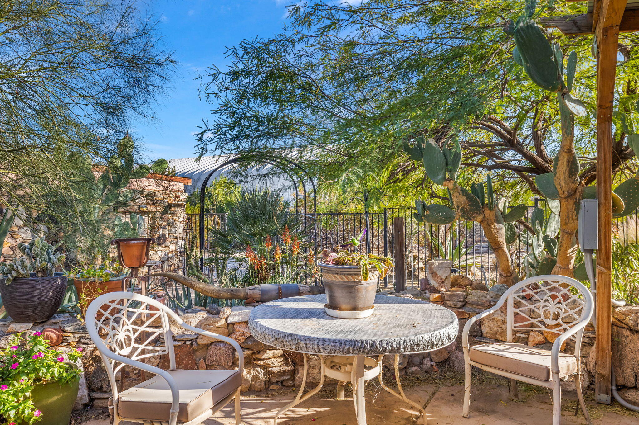 22950 Henry Road Desert Hot Springs, CA 92241 - Photo 34 of 68 a view of a patio with table and chairs and potted plants