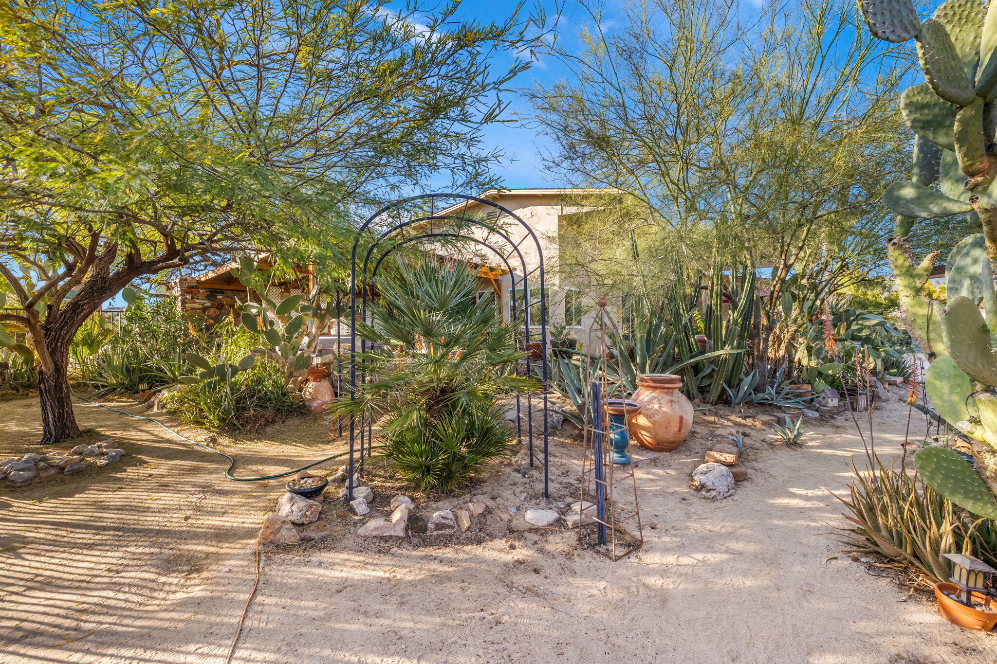 22950 Henry Road Desert Hot Springs, CA 92241 - Photo 36 of 68 a backyard of a house with table and chairs