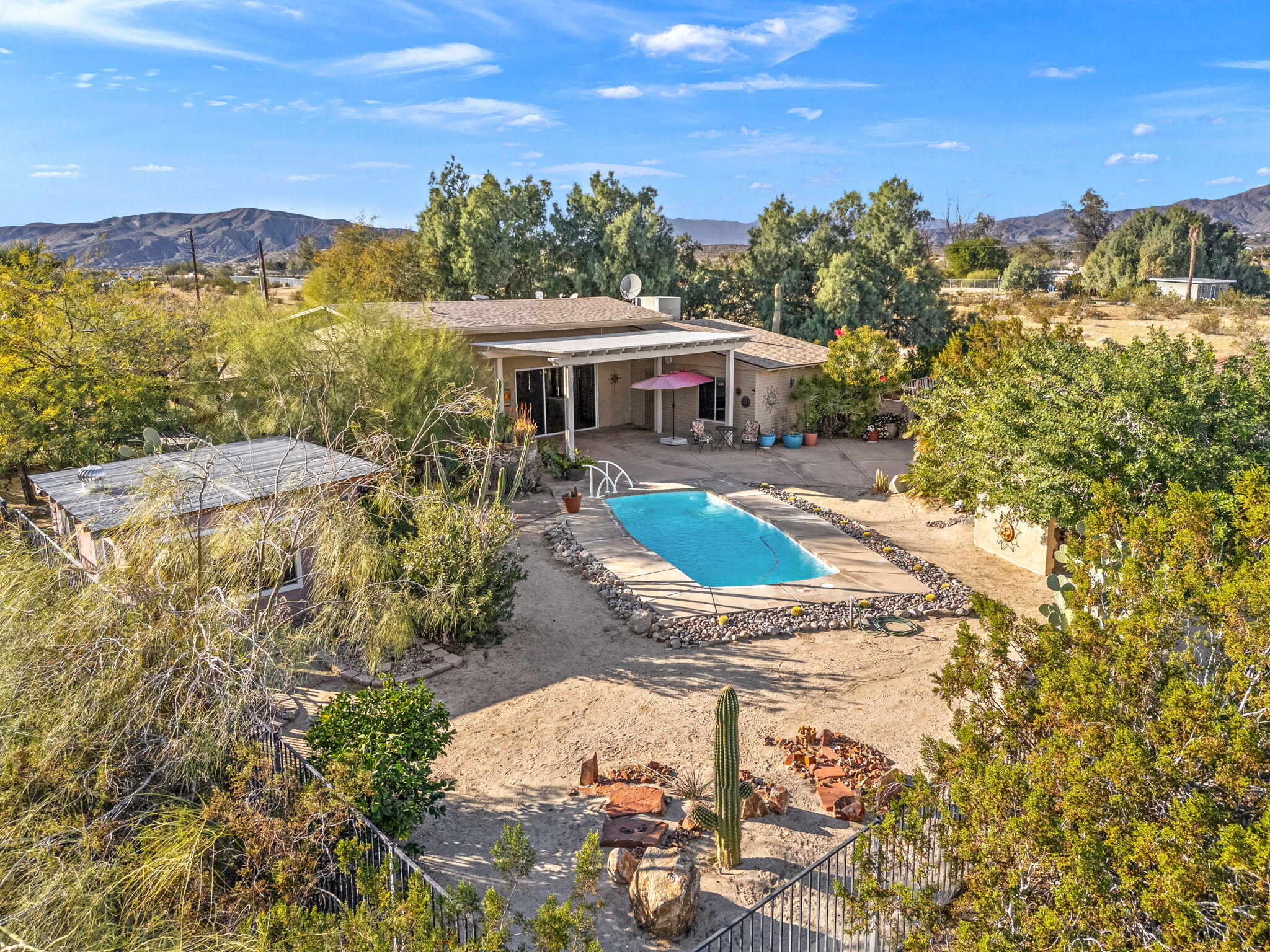 22950 Henry Road Desert Hot Springs, CA 92241 - Photo 39 of 68 a view of a swimming pool with a patio