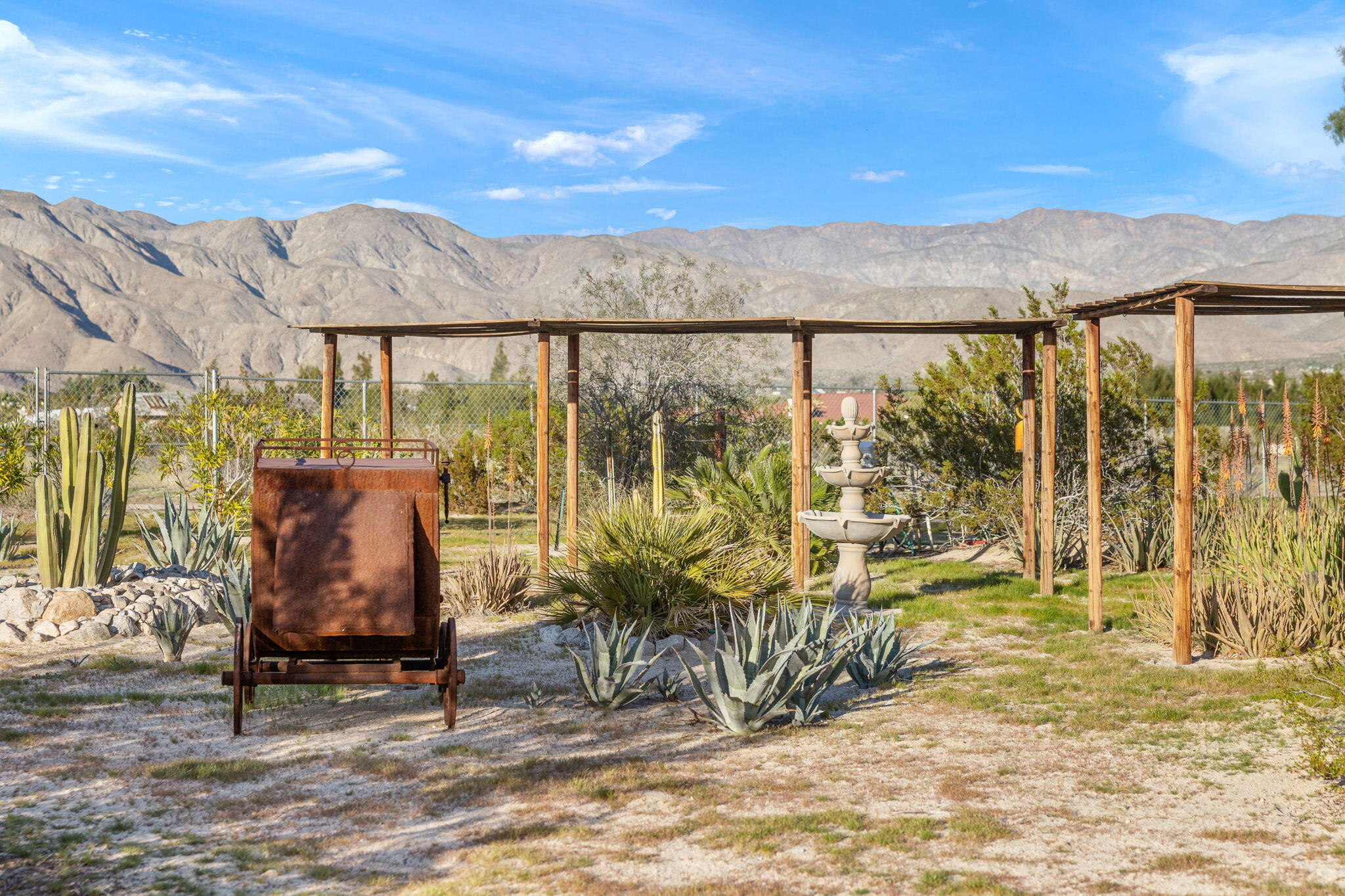 22950 Henry Road Desert Hot Springs, CA 92241 - Photo 41 of 68 a view of a patio with a table and chairs