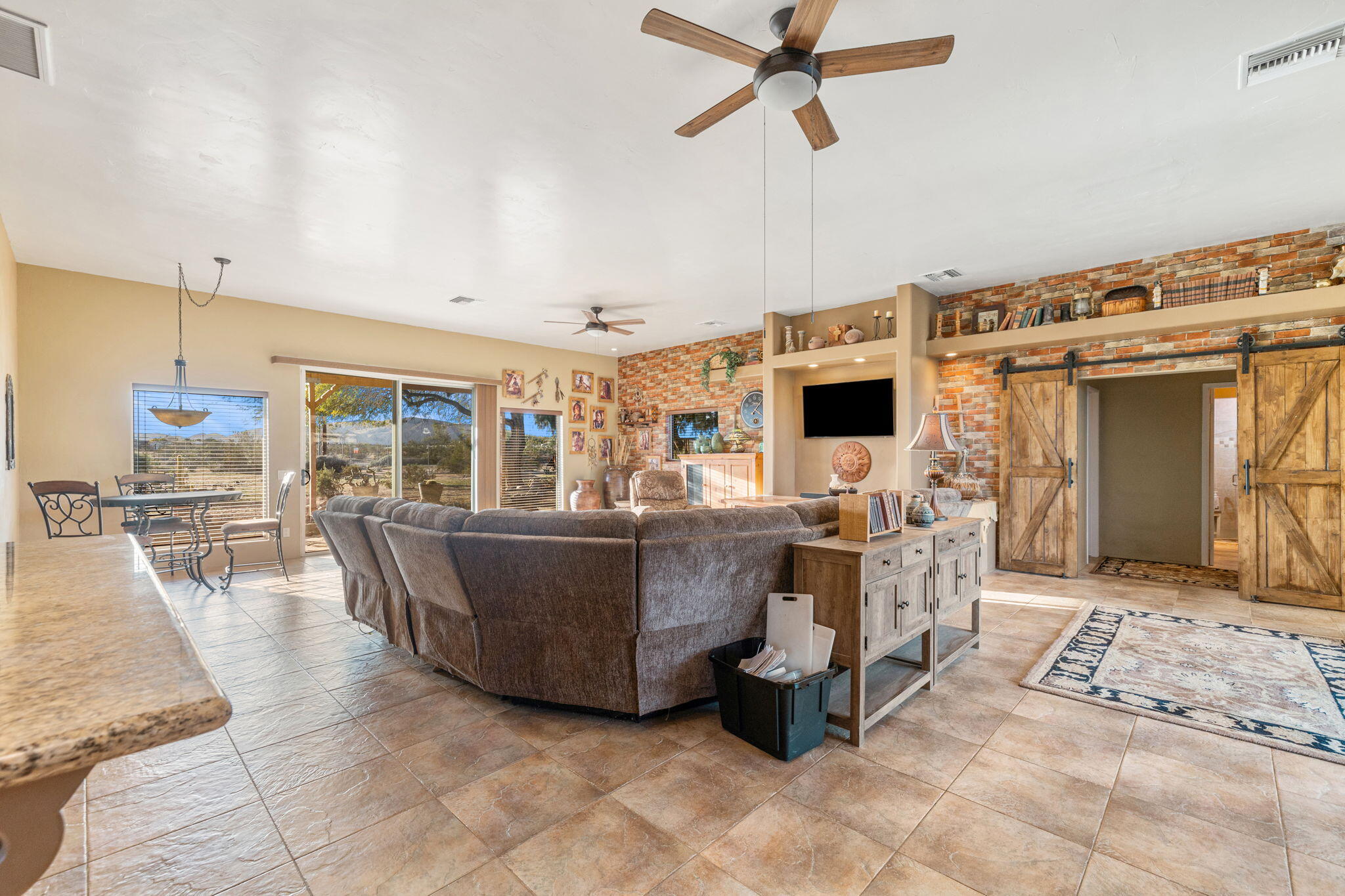 22950 Henry Road Desert Hot Springs, CA 92241 - Photo 5 of 68 a living room with couches and a dining table with kitchen view