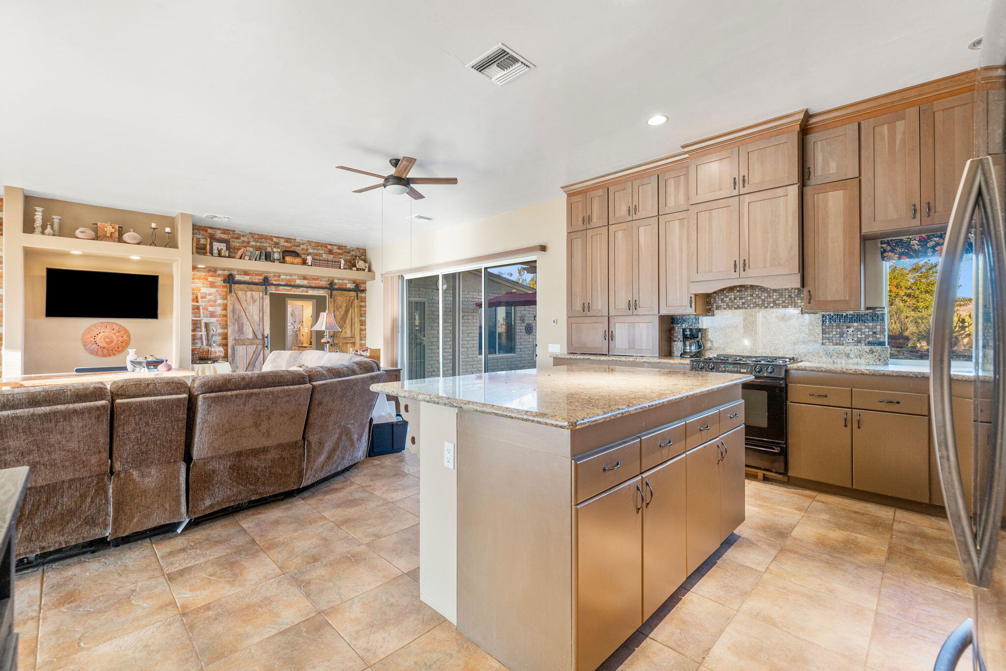 22950 Henry Road Desert Hot Springs, CA 92241 - Photo 9 of 68 a kitchen with a stove a sink and a refrigerator