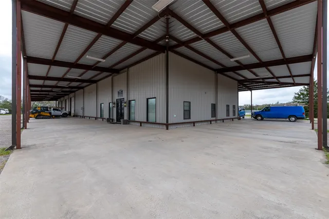 a view of a livingroom with workspace and a window
