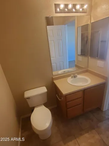 a bathroom with a sink a toilet and mirror