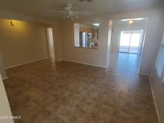 an empty room with windows and entrance