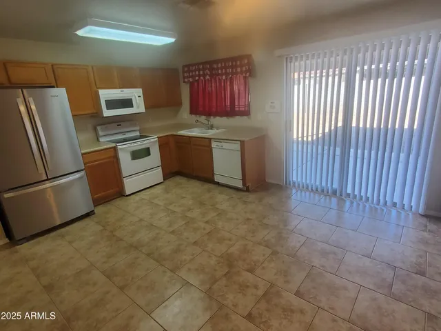 a kitchen with stainless steel appliances a refrigerator sink and stove