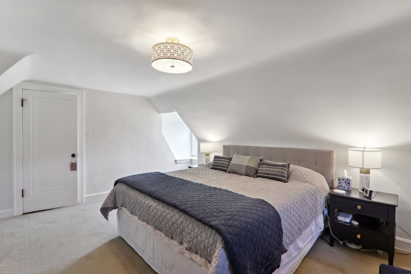 5853 North Central Avenue Chicago, IL 60646 - Photo 16 of 31 a bedroom with a bed and a chandelier