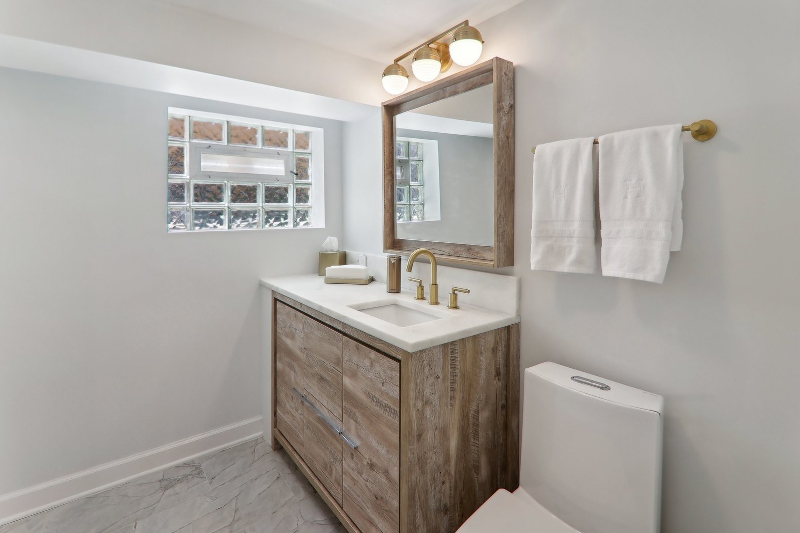 5853 North Central Avenue Chicago, IL 60646 - Photo 21 of 31 a bathroom with a sink and a mirror