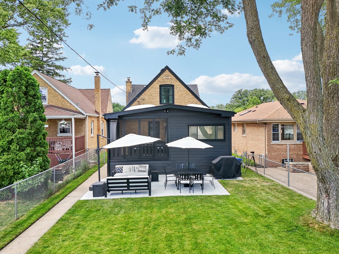 5853 North Central Avenue Chicago, IL 60646 - Photo 23 of 31 a front view of a house with a yard table and chairs