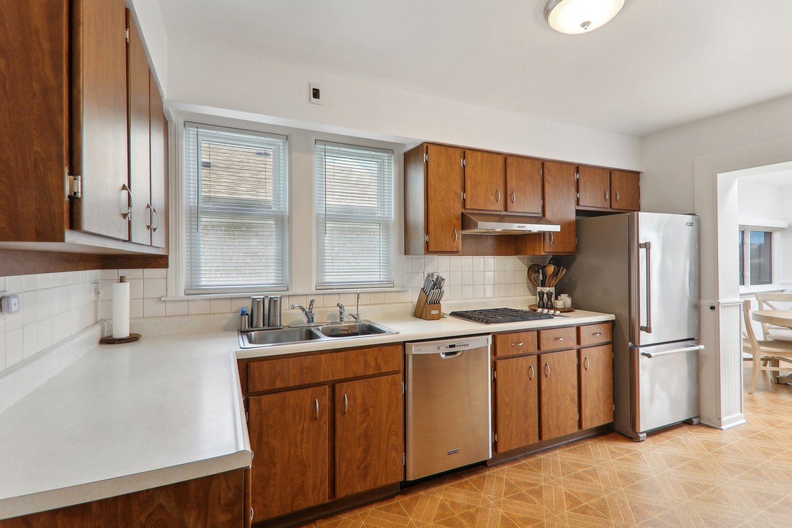 5853 North Central Avenue Chicago, IL 60646 - Photo 7 of 31 a kitchen with a sink stove and refrigerator