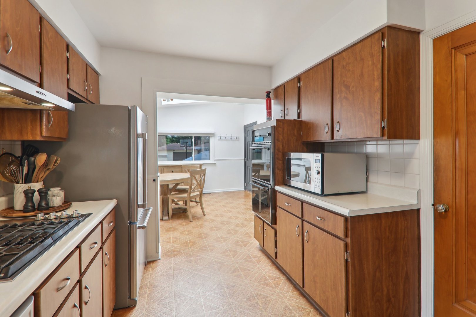 5853 North Central Avenue Chicago, IL 60646 - Photo 8 of 31 a kitchen with stainless steel appliances granite countertop a refrigerator and a stove