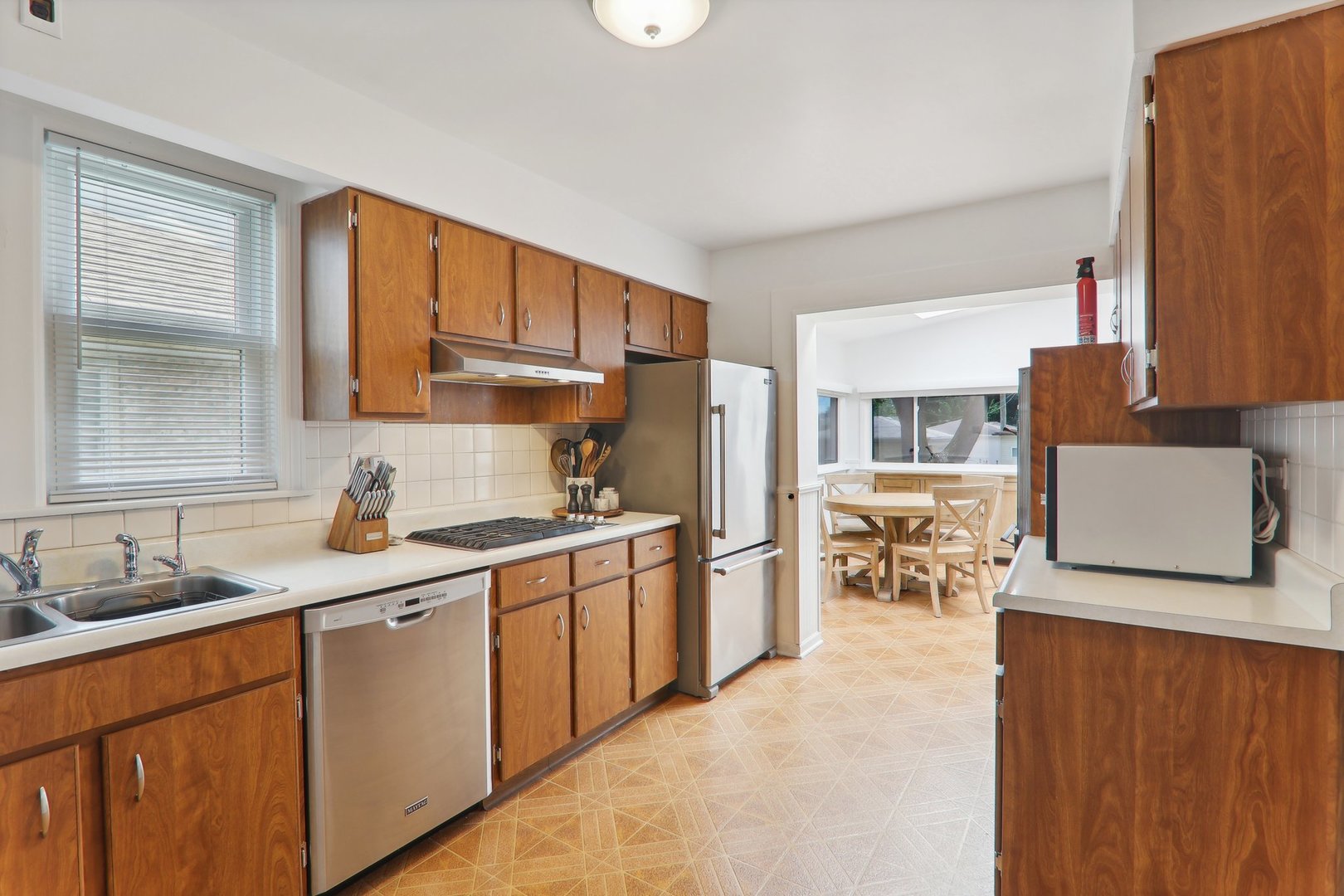 5853 North Central Avenue Chicago, IL 60646 - Photo 9 of 31 a kitchen with stainless steel appliances granite countertop a sink stove and refrigerator