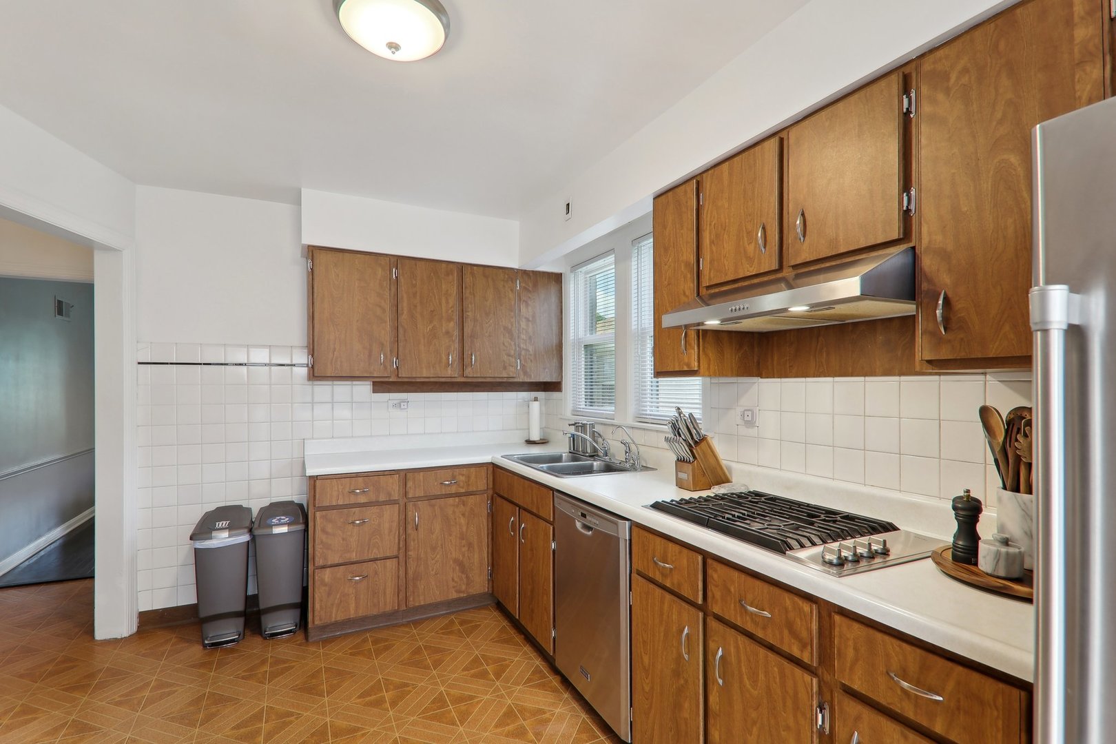5853 North Central Avenue Chicago, IL 60646 - Photo 10 of 31 a kitchen with a sink stove and cabinets