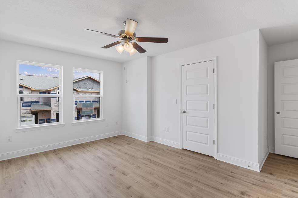 3 Renea Cove Destin, FL 32541 - Photo 11 of 26 a view of an empty room with a window and wooden floor