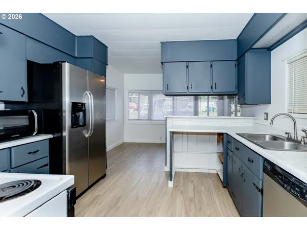 a kitchen with a sink appliances and cabinets