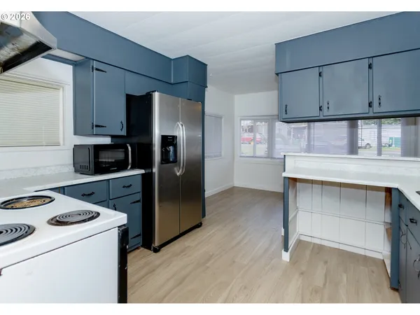 a kitchen with kitchen island a cabinets appliances and a counter top