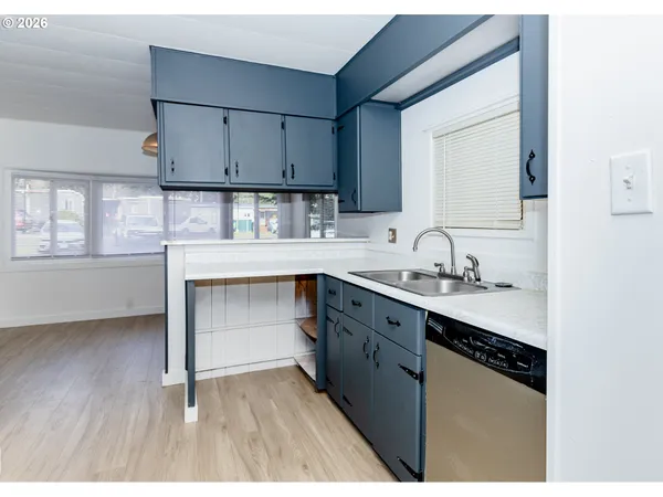 a kitchen with granite countertop white cabinets and appliances