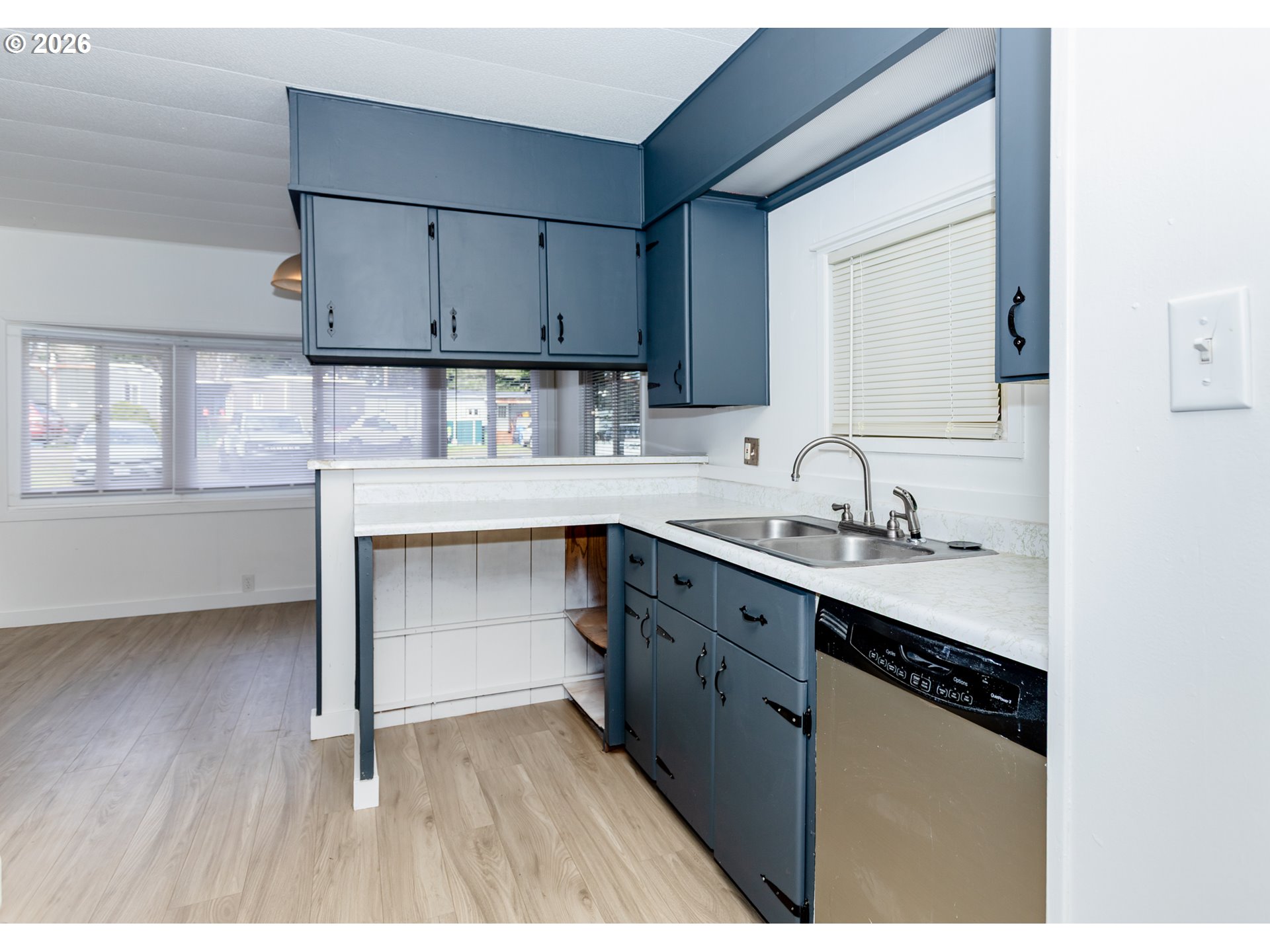 5170 Grand Avenue, Unit 38 Florence, OR 97439 - Photo 13 of 27 a kitchen with granite countertop white cabinets and appliances