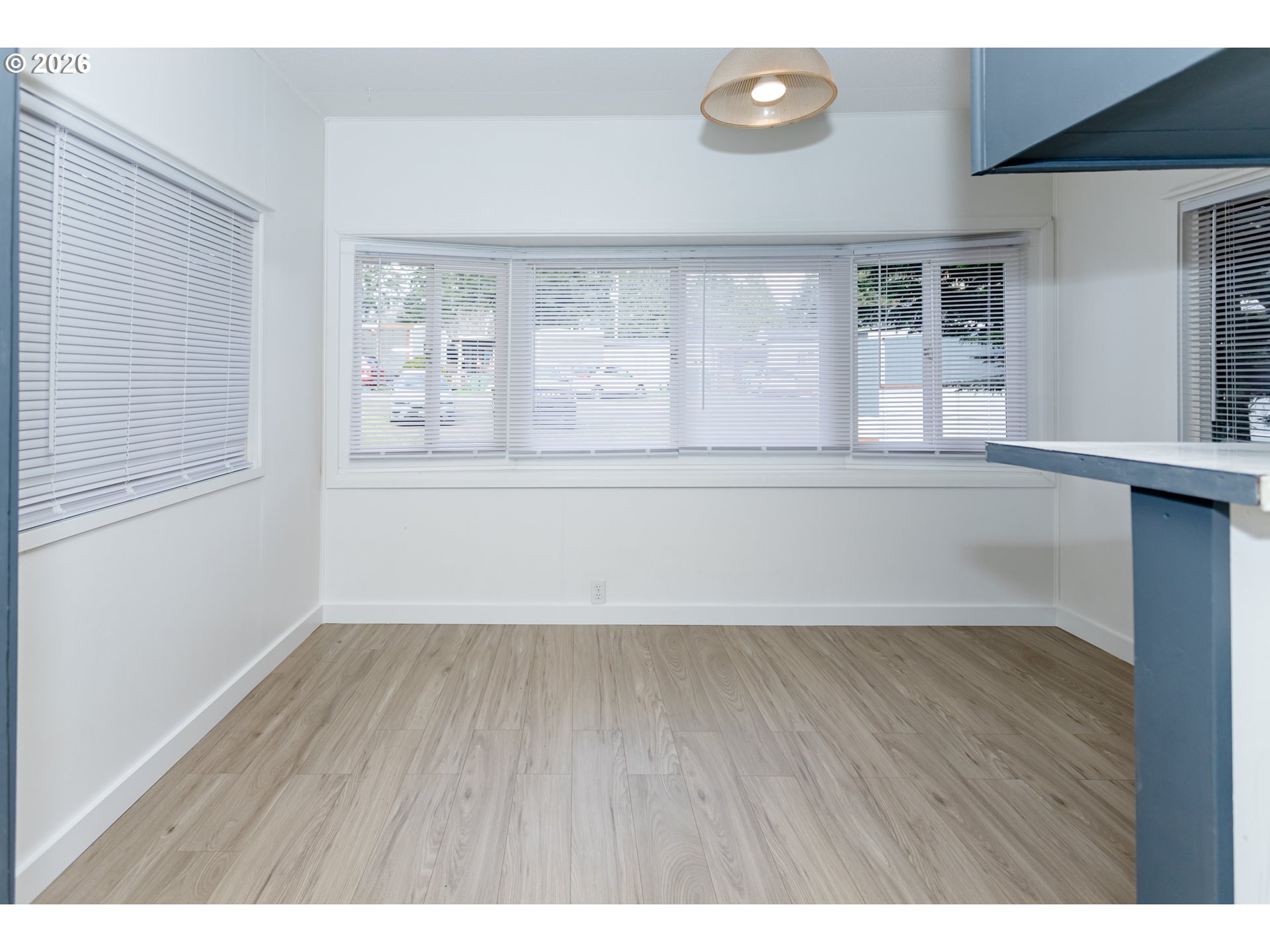5170 Grand Avenue, Unit 38 Florence, OR 97439 - Photo 14 of 27 a view of an empty room with wooden floor and a window