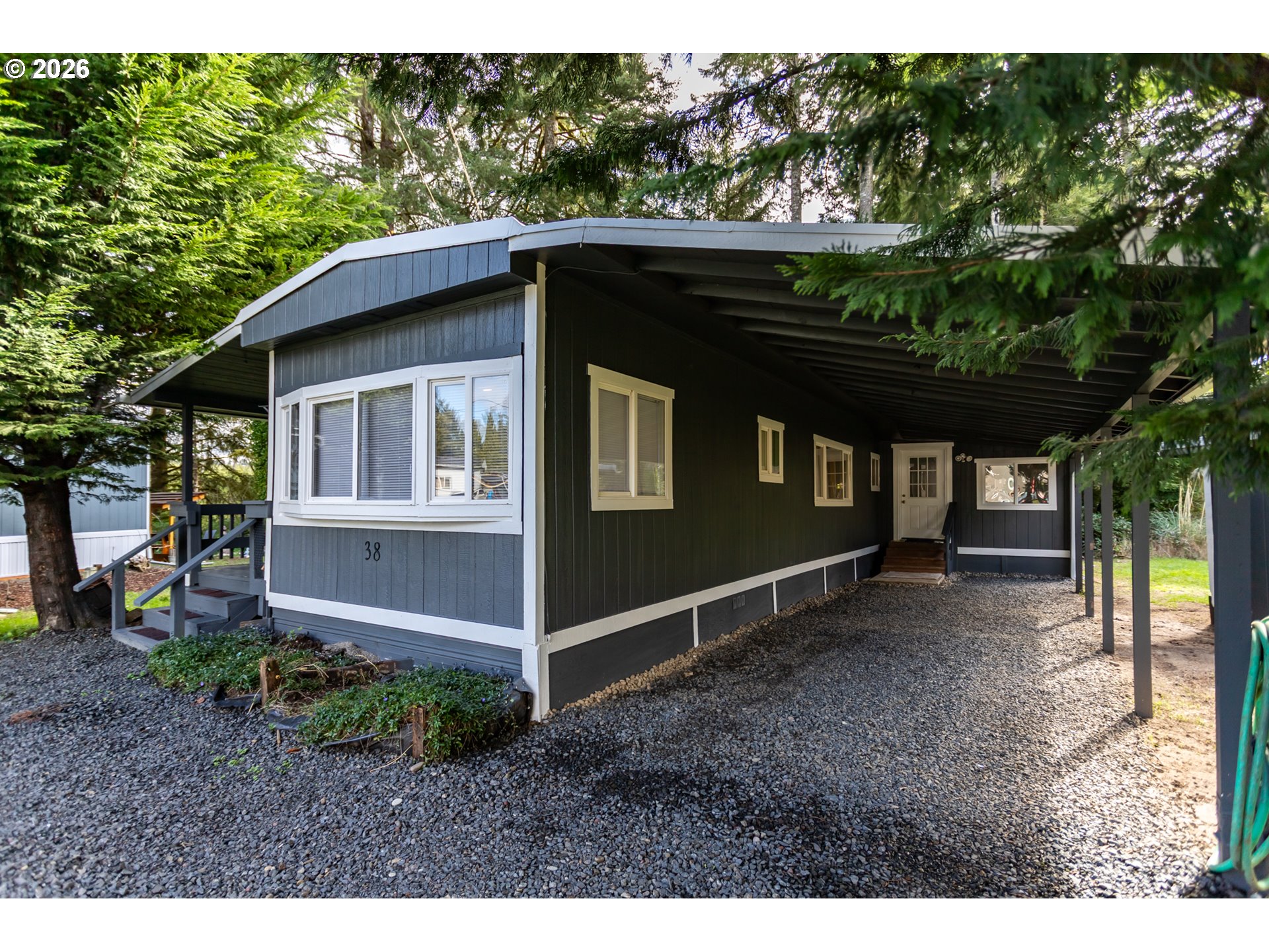 5170 Grand Avenue, Unit 38 Florence, OR 97439 - Photo 2 of 27 a backyard of a house with lots of green space