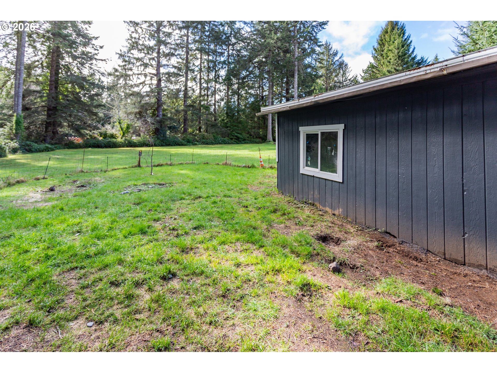 5170 Grand Avenue, Unit 38 Florence, OR 97439 - Photo 26 of 27 a view of a backyard with large trees