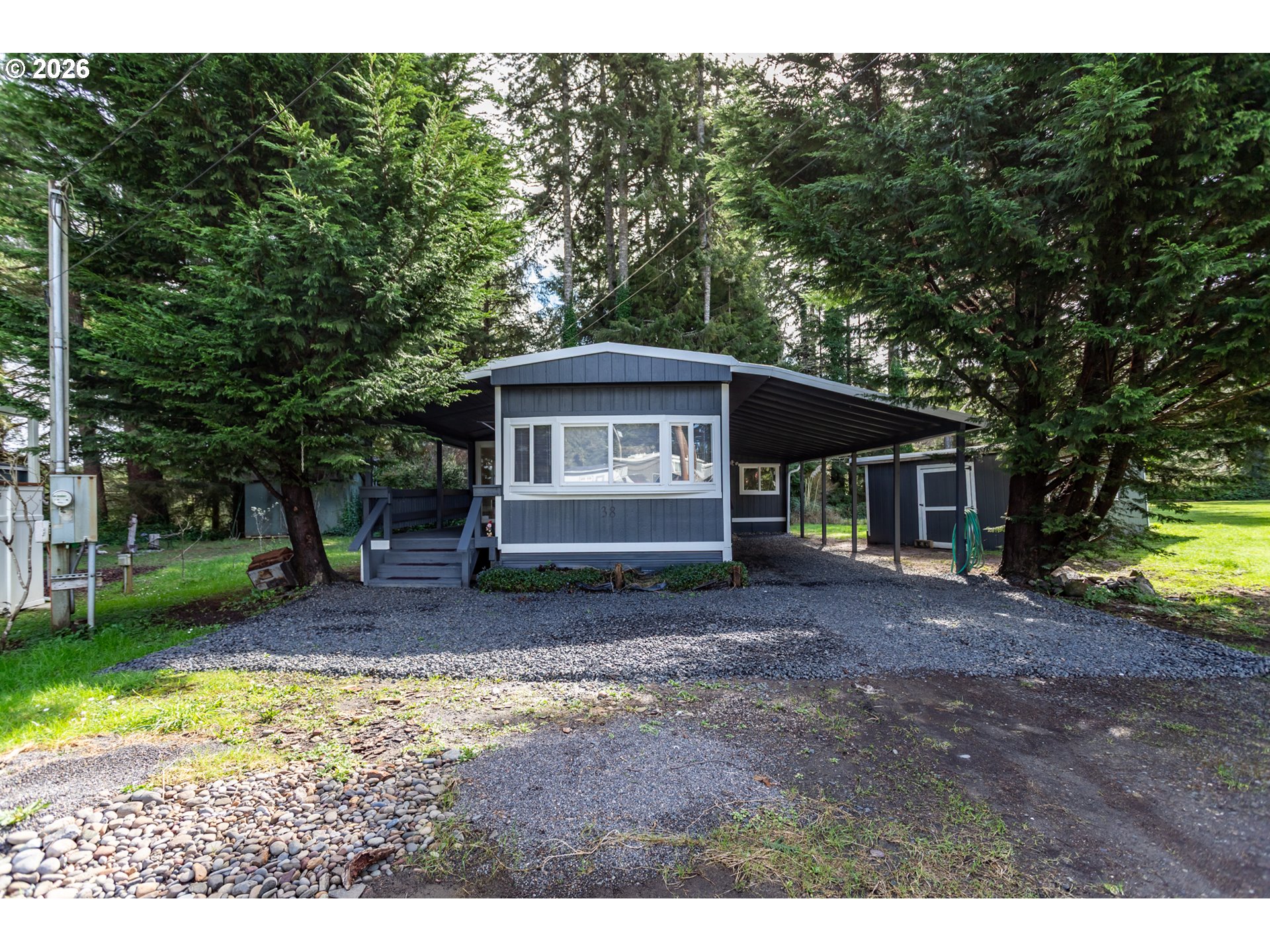 5170 Grand Avenue, Unit 38 Florence, OR 97439 - Photo 3 of 27 a view of a house with yard and tree s