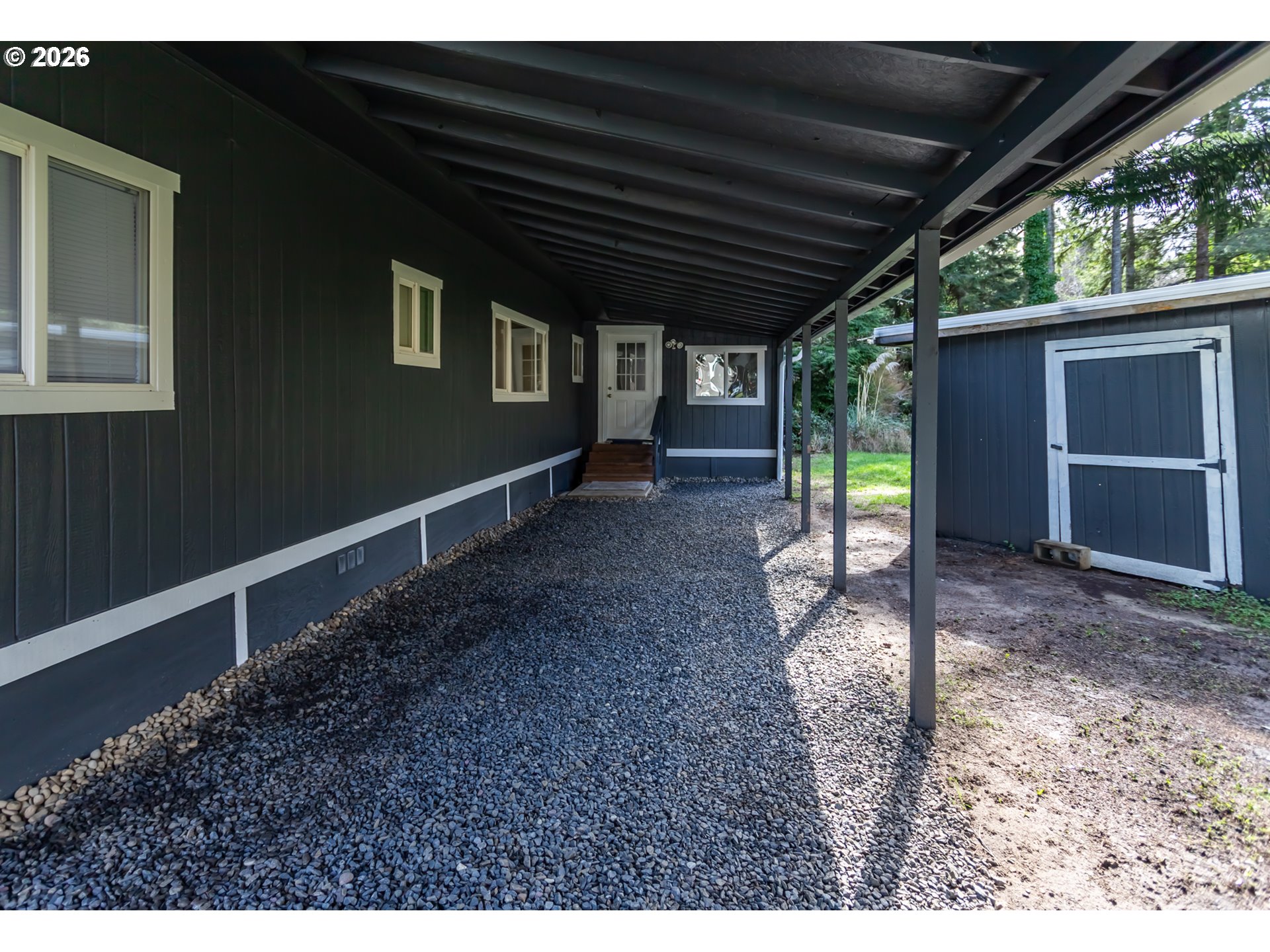 5170 Grand Avenue, Unit 38 Florence, OR 97439 - Photo 5 of 27 a view of a house with a backyard