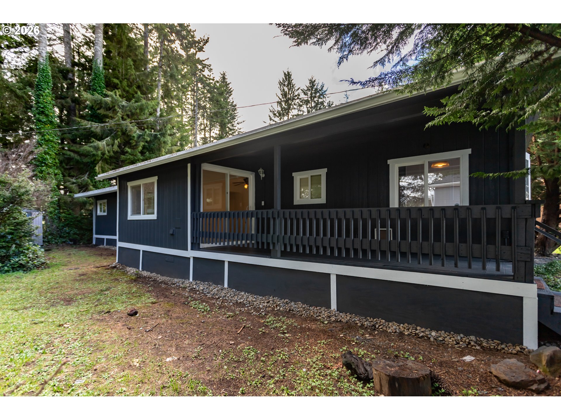 5170 Grand Avenue, Unit 38 Florence, OR 97439 - Photo 7 of 27 a view of a house with a yard