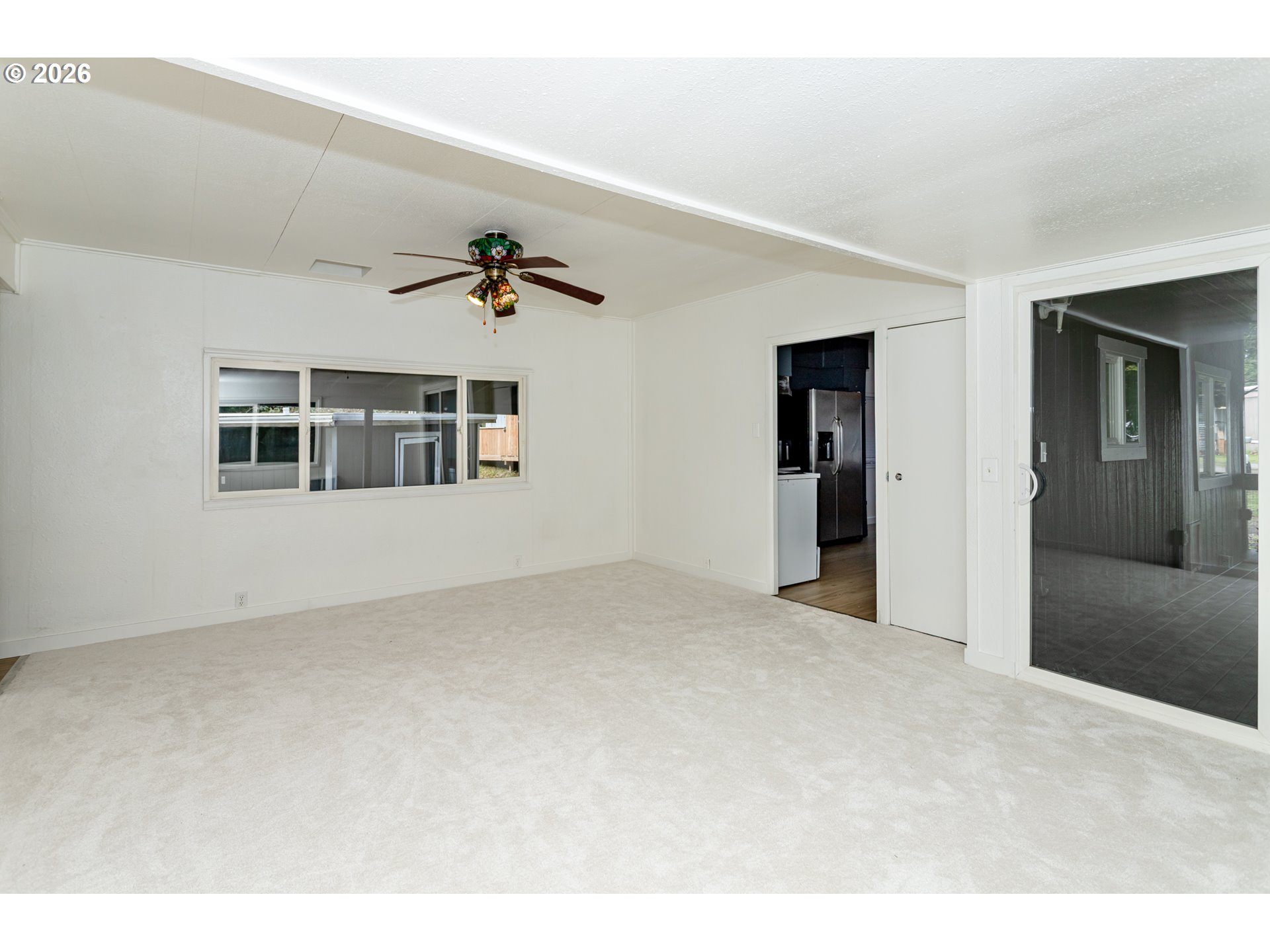 5170 Grand Avenue, Unit 38 Florence, OR 97439 - Photo 9 of 27 a view of a big room with windows and chandelier fan