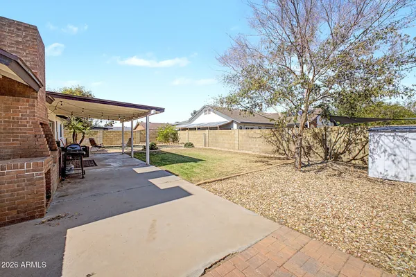 a view of a house with swimming pool and sitting area