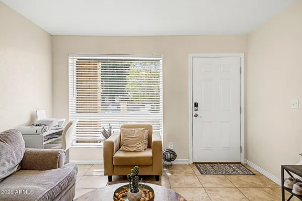 a living room with furniture and floor to ceiling window
