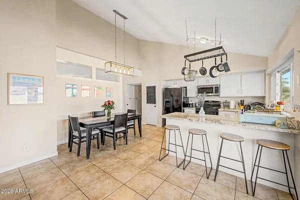 a view of a dining room kitchen island furniture and chandelier
