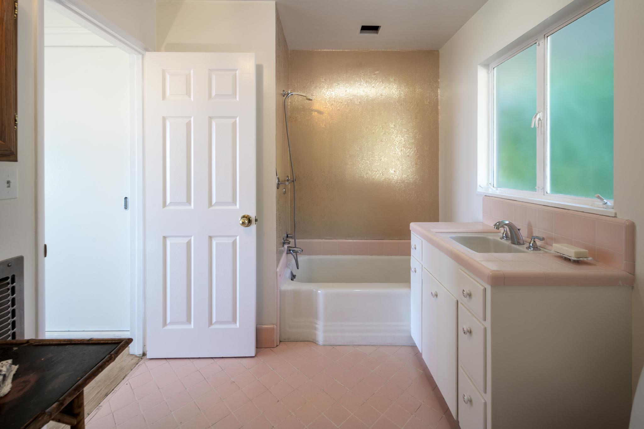 929 Arbolado Road Santa Barbara, CA 93103 - Photo 9 of 29 a bathroom with a tub sink vanity and a mirror