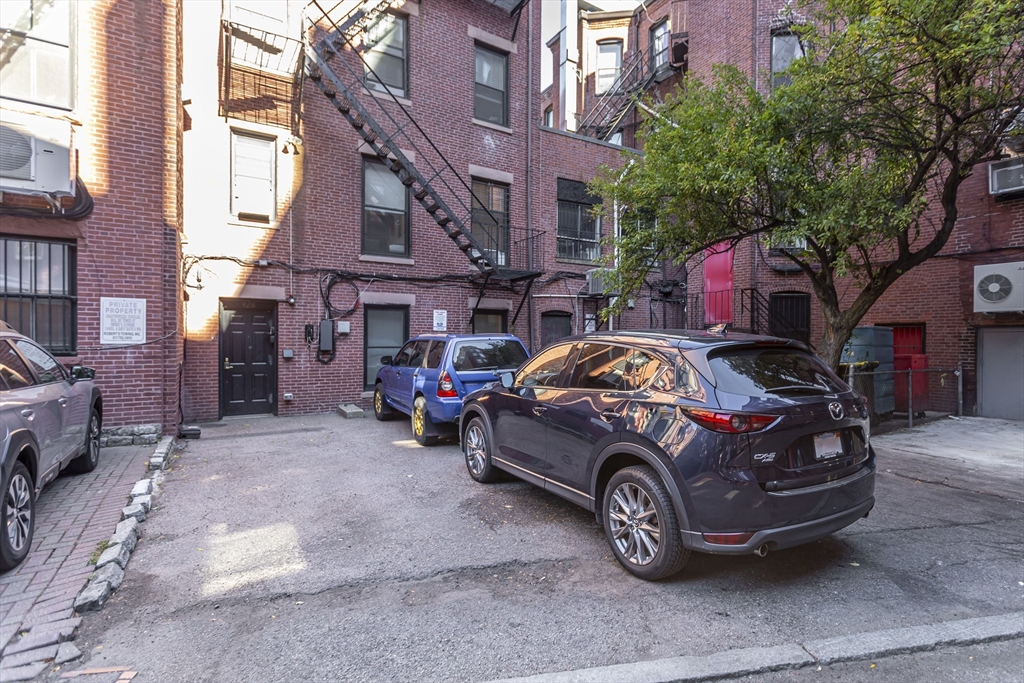 a car parked in front of a brick house