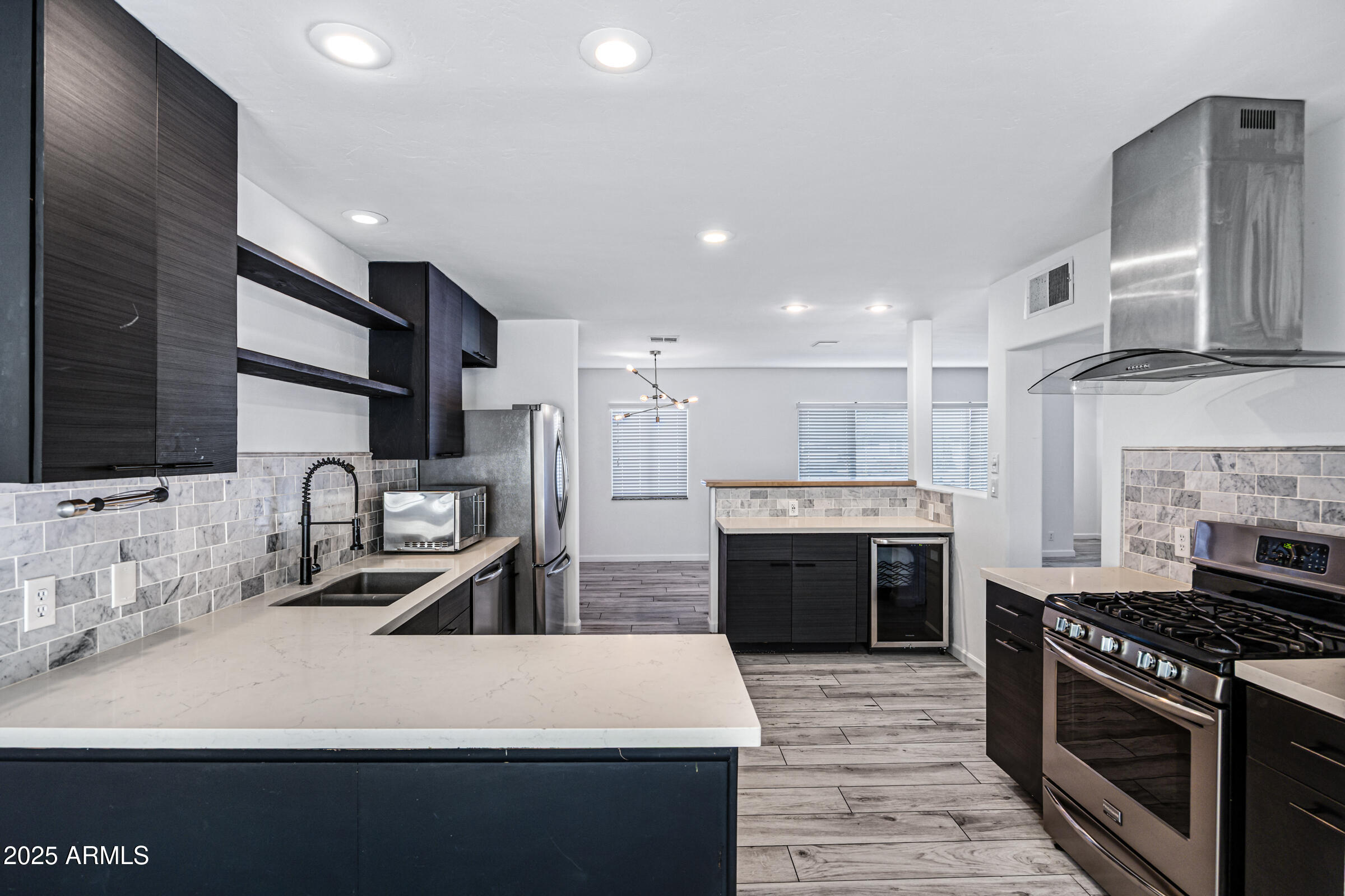 6829 East Almeria Road Scottsdale, AZ 85257 - Photo 1 of 35 a large kitchen with stainless steel appliances granite countertop a stove refrigerator and cabinets
