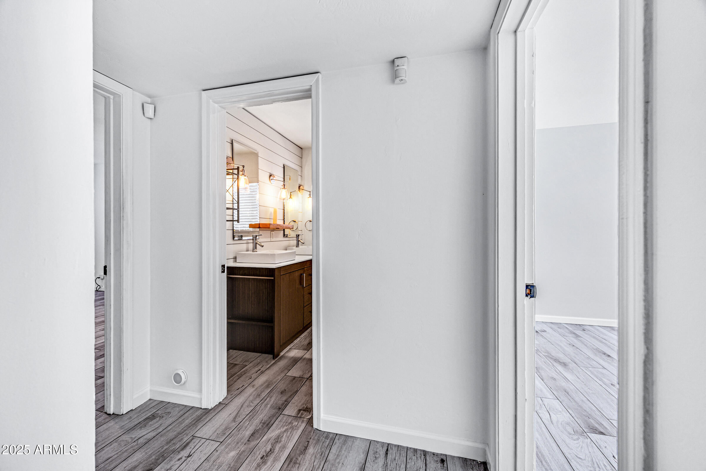 6829 East Almeria Road Scottsdale, AZ 85257 - Photo 16 of 35 a view of a hallway to an empty room and wooden floor