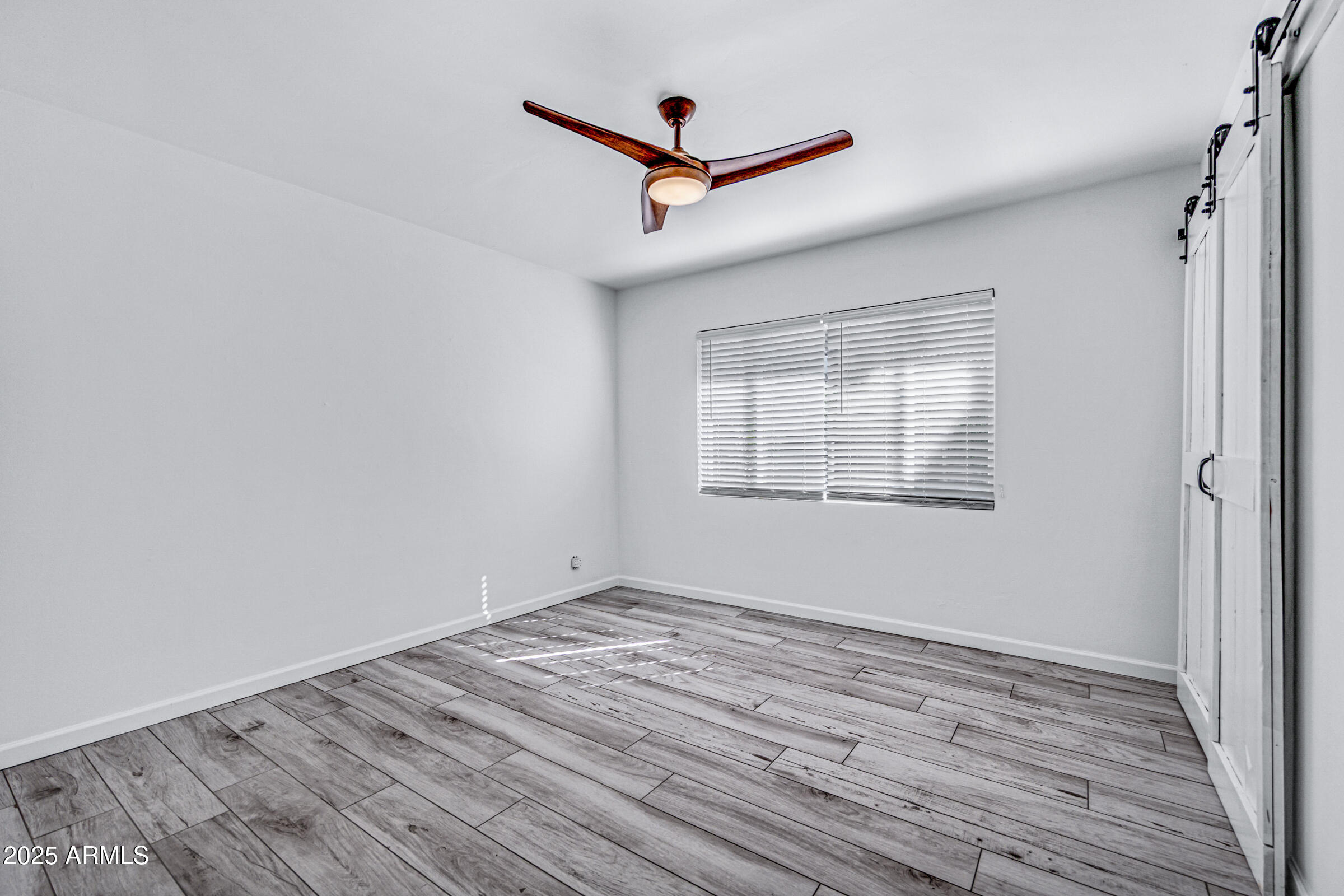6829 East Almeria Road Scottsdale, AZ 85257 - Photo 19 of 35 a view of empty room with wooden floor and fan