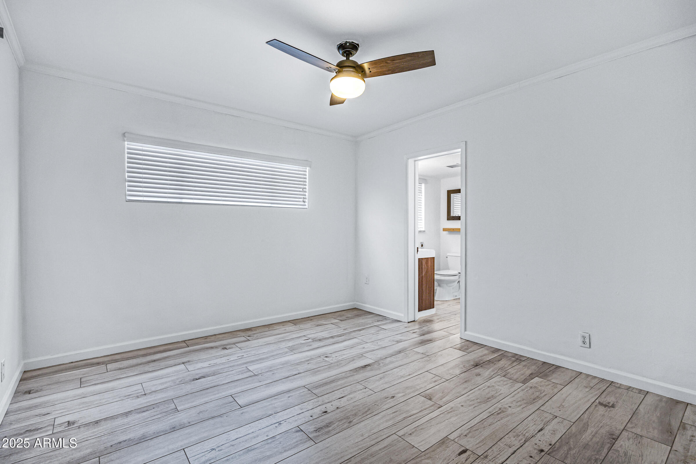 6829 East Almeria Road Scottsdale, AZ 85257 - Photo 22 of 35 an empty room with wooden floor and windows