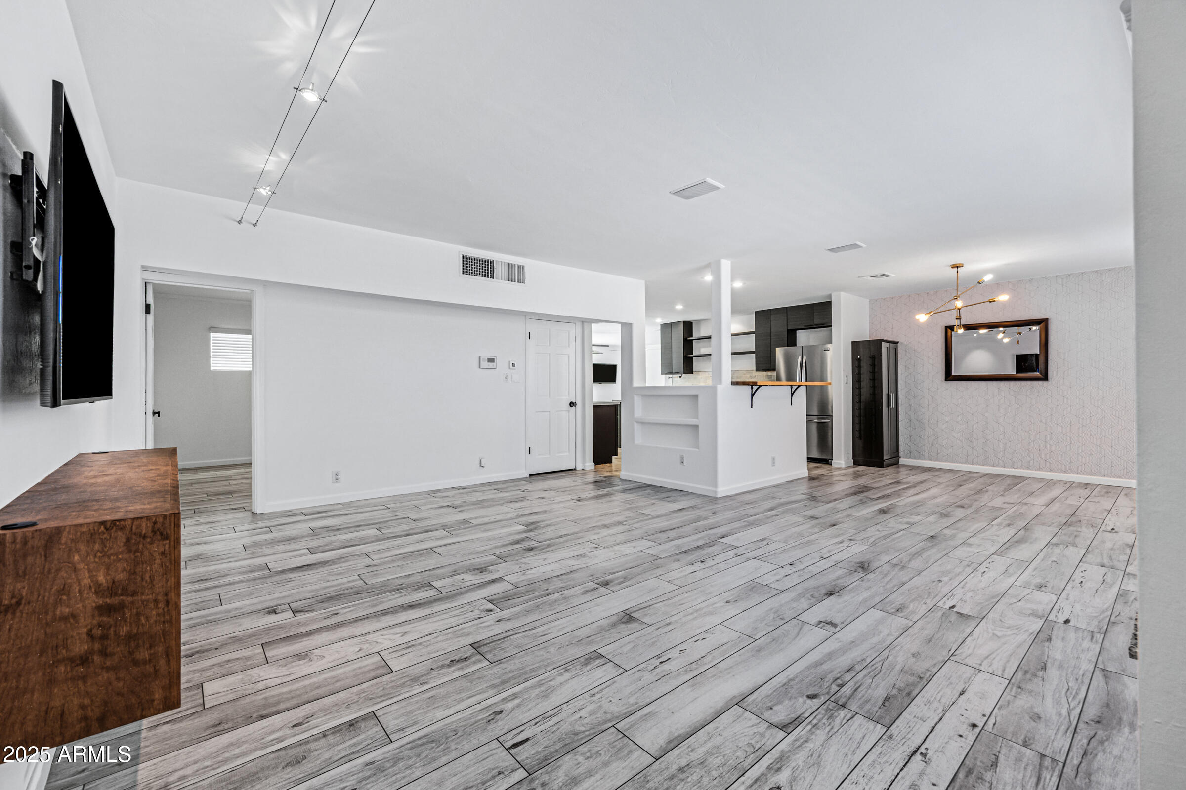 6829 East Almeria Road Scottsdale, AZ 85257 - Photo 3 of 35 a view of empty room with wooden floor