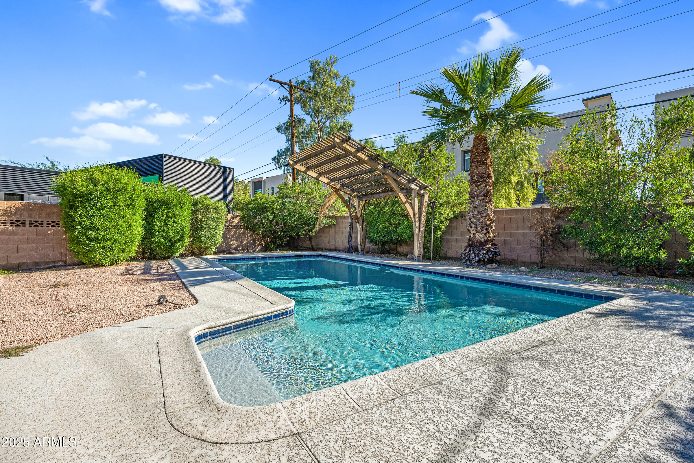 6829 East Almeria Road Scottsdale, AZ 85257 - Photo 31 of 35 a view of a backyard with plants and palm tree