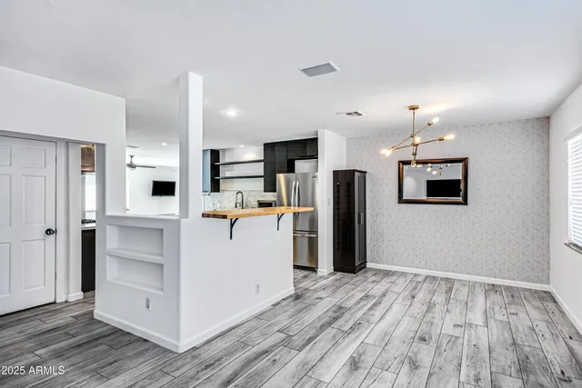 a view of kitchen with refrigerator microwave and wooden floor